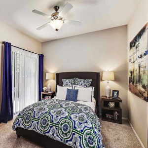 bedroom of model home at Oakhaven with ceiling fan and sliding glass door