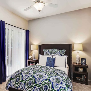 bedroom of model home at Oakhaven with ceiling fan and sliding glass door