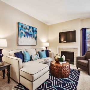 Blue tones in the living room of the model at Oakhaven with woodburning fireplace and flatscreen tv