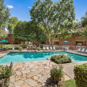 Pool at Oakhaven with lounge furniture and lush landscaping