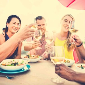 Happy Friends toasting over dinner